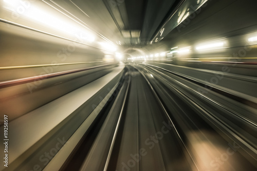 Fast underground train riding in a tunnel of the modern city