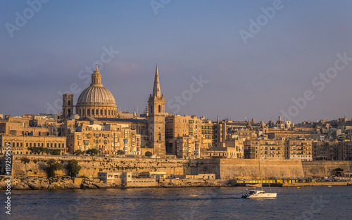 Valletta, Malta - The beautiful St.Paul's Cathedral and the ancient city of Valletta at sunset with clear blue sky