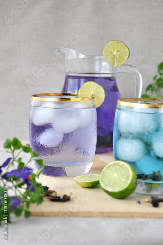 Glass of Butterfly Pea Drinks with Jar on Background