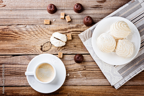 Plate of tasty zephyr on wooden table.  top view dessert image.