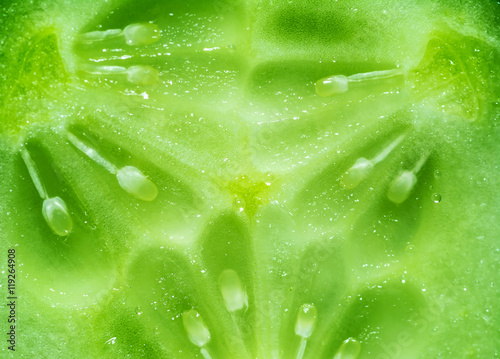 Core green fresh cucumber cut in half close-up background