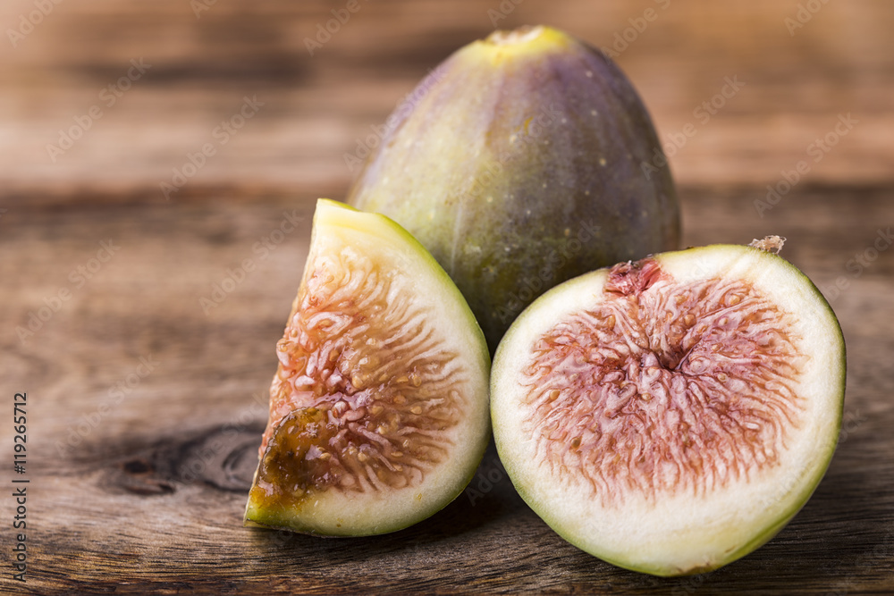 sliced of a fig isolated on wooden background sliced of a fig isolated on wooden background