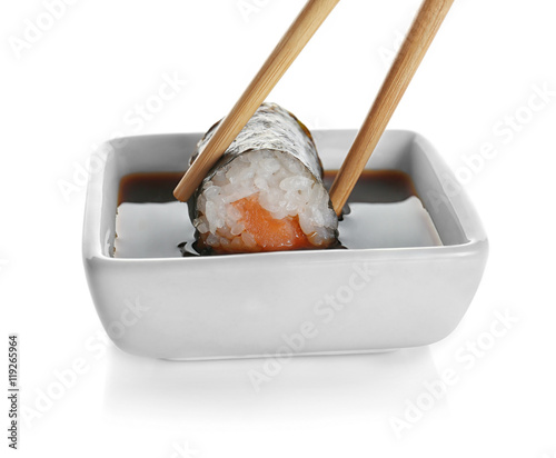 Delicious sushi roll with soy sauce, isolated on white
