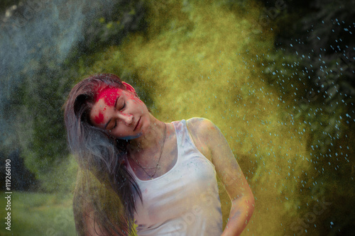 Woman with hair motion and yellow powder around her