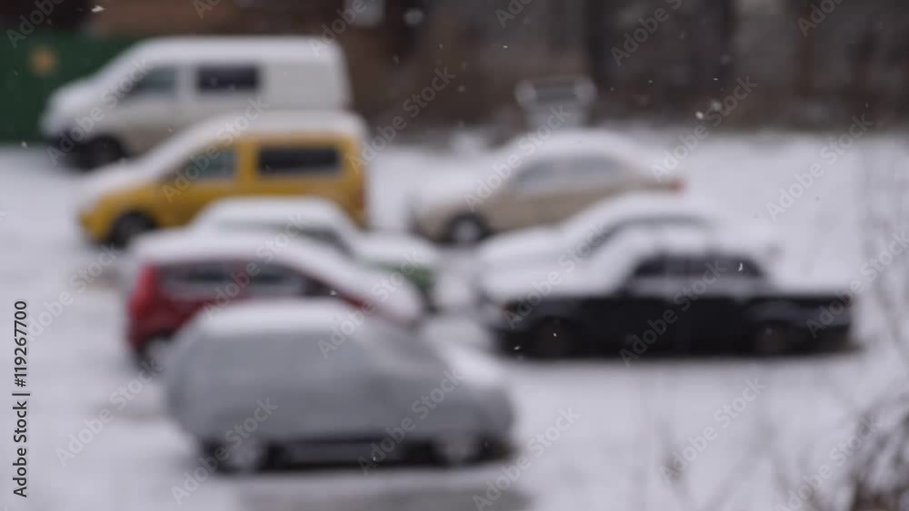 Slanting snow falling on background of blurred parking place Slanting snow falling on background of blurred parking place