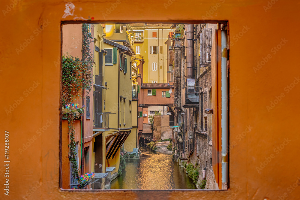 water canal hidden behind a window in Italy