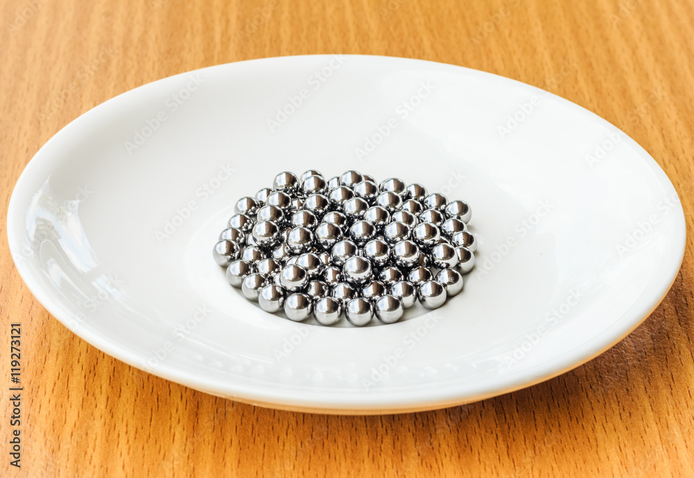bearings in a dish on wooden table