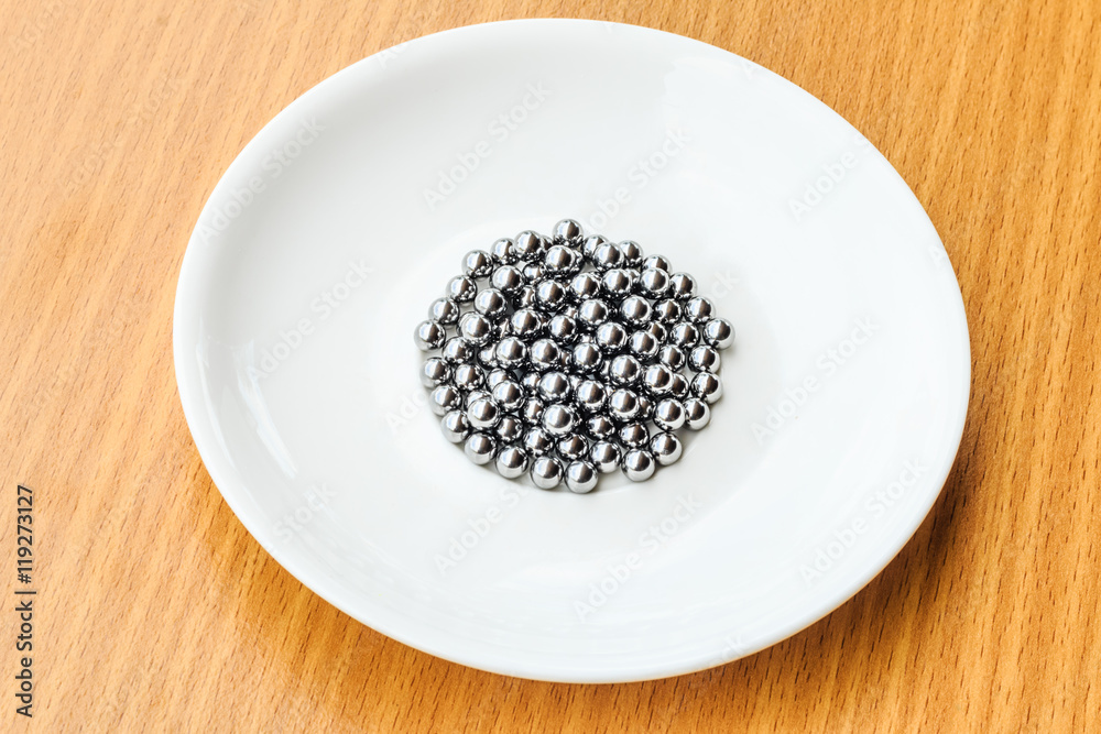 bearings in a dish on wooden table