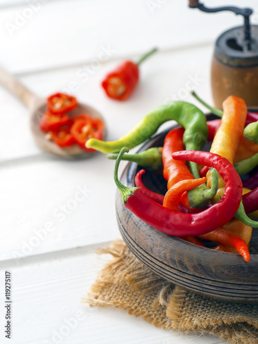 Red, green and yellow peppers in a bowl
