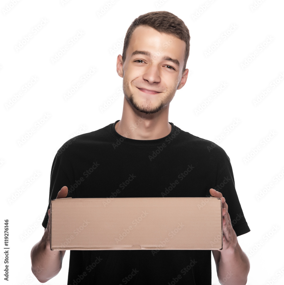 Smiling young delivery man holding and carrying a cardbox isolated on white background Smiling young delivery man holding and carrying a cardbox isolated on white background