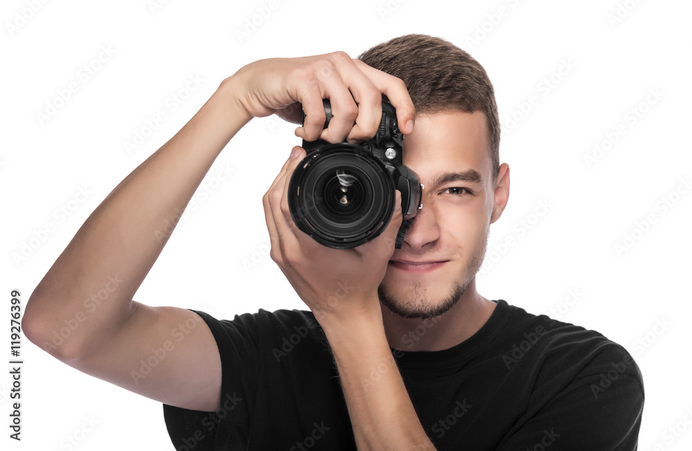 Handsome young man holding a DSLR camera. Handsome young man holding a DSLR camera.
