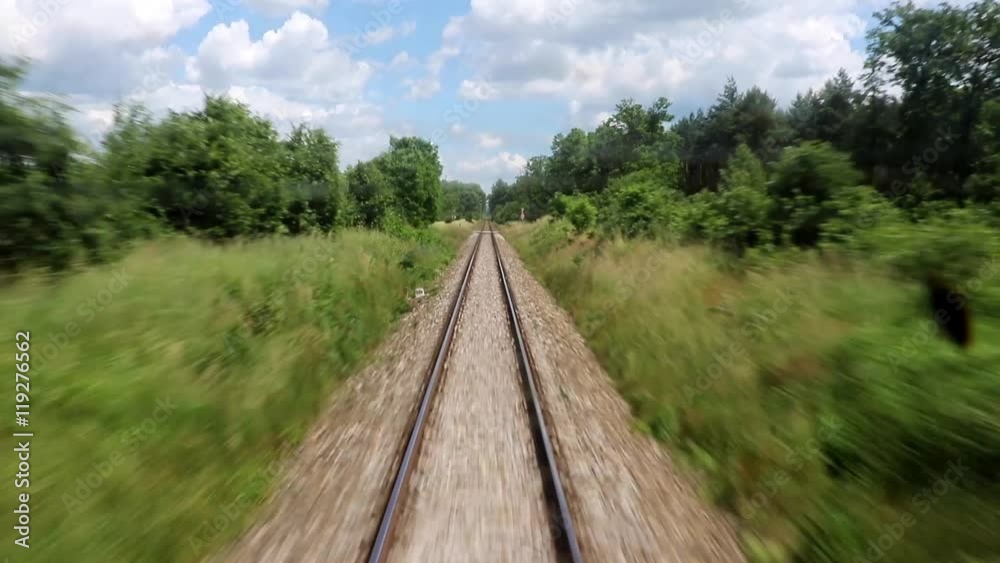 Railroad tracks in summer nature behind a passing train Railroad tracks in summer nature behind a passing train