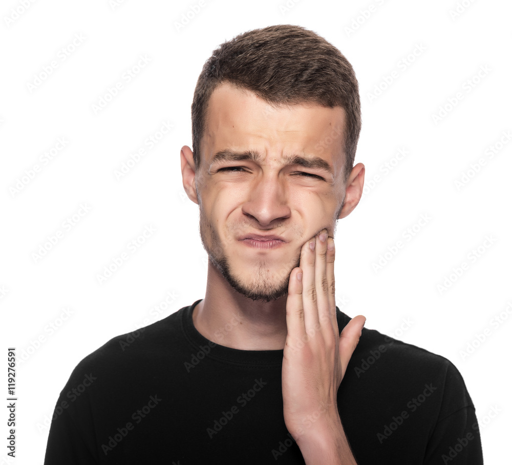 Toothache. Portrait of a man with face closed by hand.