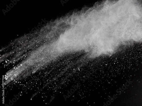 Freeze motion of white dust explosions isolated on black 