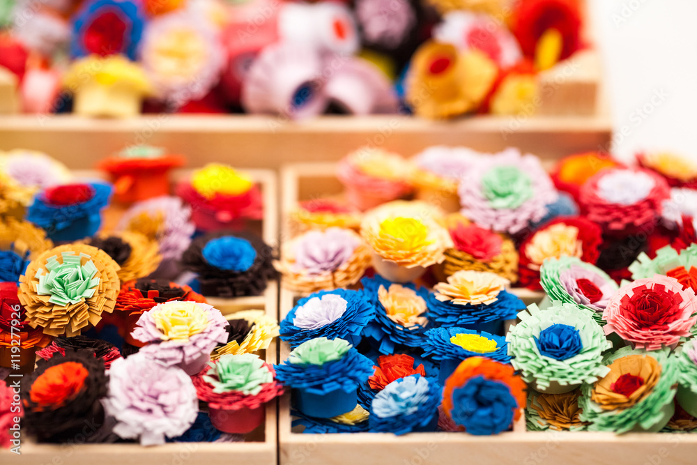 Small, colorful paper flowers made with quilling technique - details
