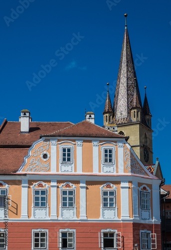 Apartment house and steeple of Saint Mary Lutheran Cathedral in Sibiu city in Romania © Fotokon