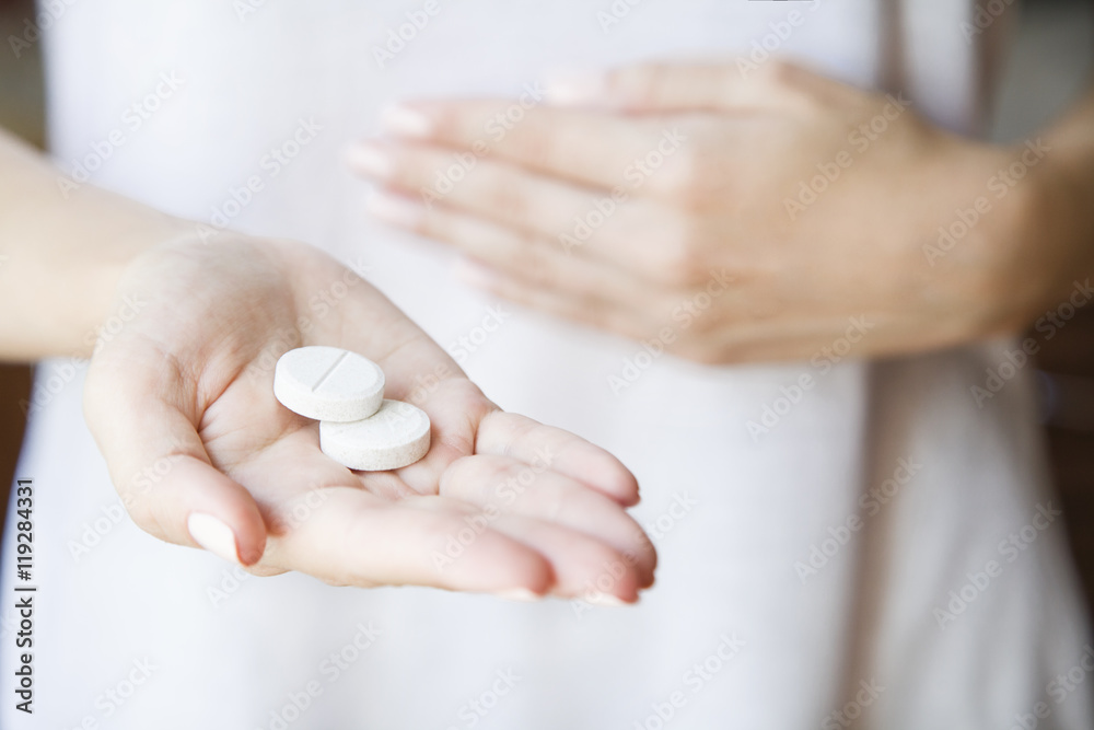 Woman is holding a lot of different pills in her hands Woman is holding a lot of different pills in her hands
