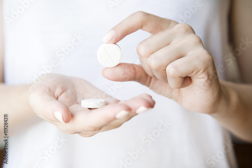 Pills in women's hands.