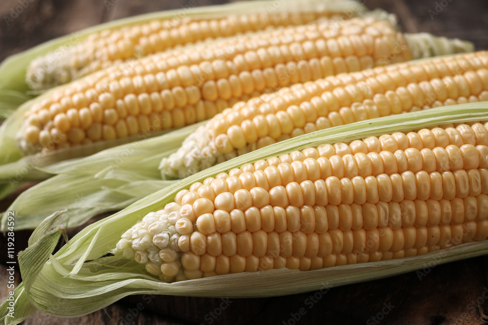 Fresh corn on cobs on rustic wooden table, closeup Fresh corn on cobs on rustic wooden table, closeup