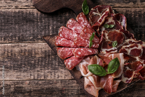 Traditional spanish tapas or italian antipasti on wooden vintage table