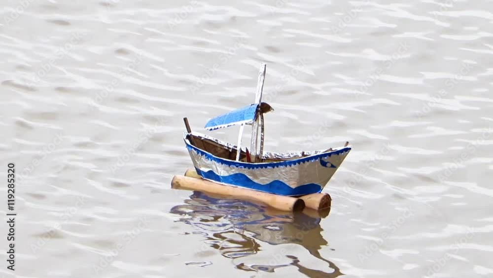 model boats swinging on the waves in the river, Phnom Penh, Cambodia model boats swinging on the waves in the river, Phnom Penh, Cambodia