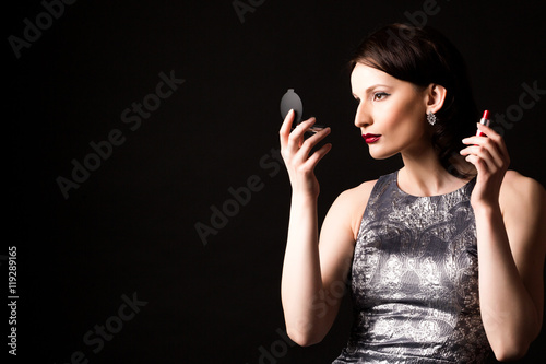 Portrait of a beautiful woman hairstyle and makeup on a black background.