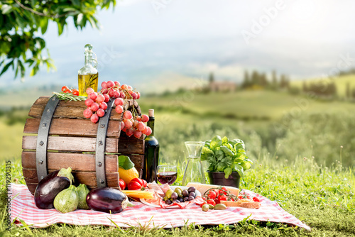 Fotografie Lots of tasty italian food on the napkin and wooden barrel outdoors on the tusca