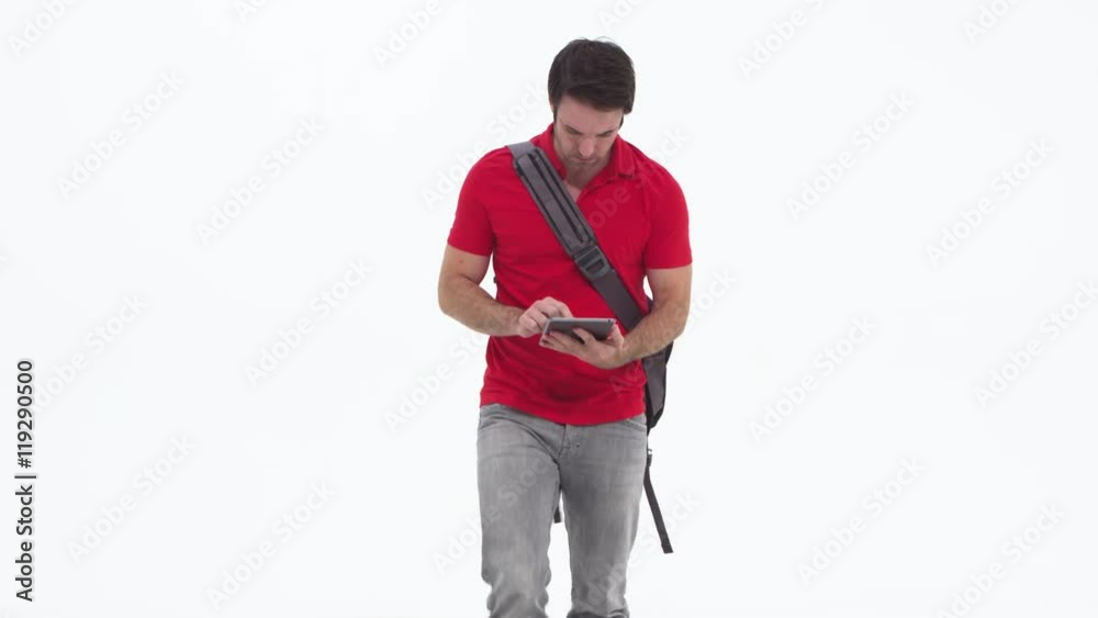 Young caucasian using tablet and walking Young caucasian using tablet and walking