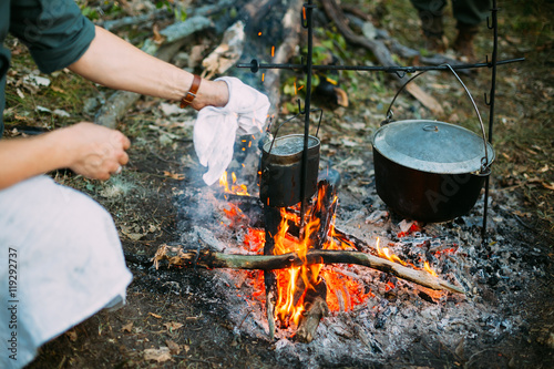 Food Is Cooked Over A Fire In An Old Marching Pot