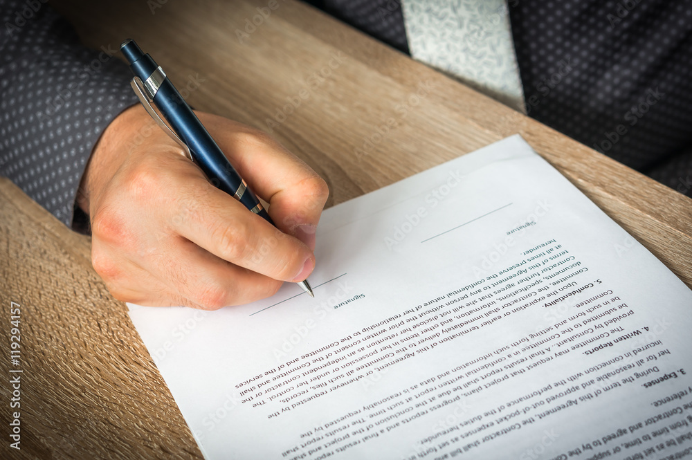 Businessman is signing a contract to conclude a deal Businessman is signing a contract to conclude a deal