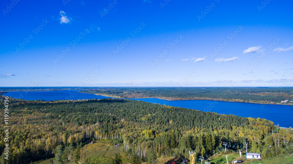 Aerial view of green forest and Red lake in Saint-Petersburg region, Russia, at summer time