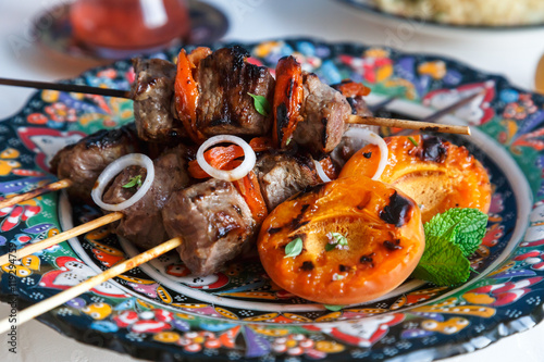 Lamb kebab marinated with yoghurt apricots served on traditional plate