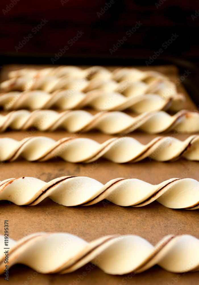 Raw chocolate puff pastry twists breadsticks freshly prepared fo Raw chocolate puff pastry twists breadsticks freshly prepared fo