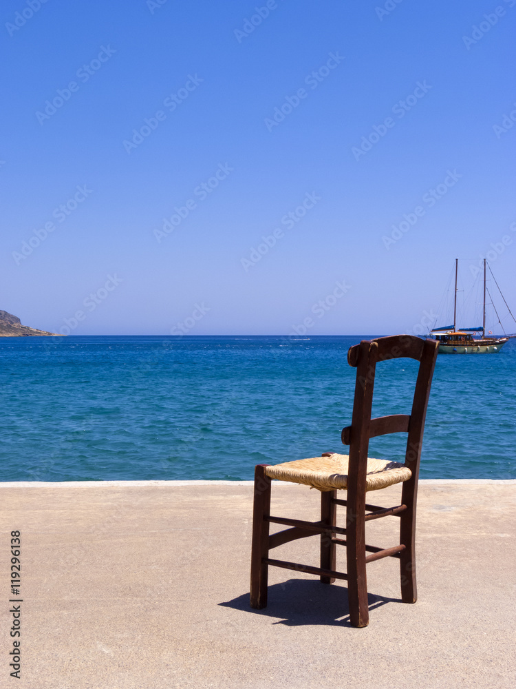 Old wooden chair near the sea - Crete, Greece