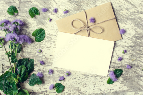 Blank white greeting card and envelope with purple wildflowers