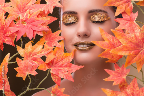 Fototapeta Naklejka Na Ścianę i Meble -  Young woman with dry autumn leaves