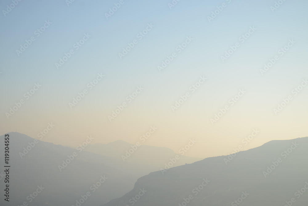 Hazy Muted Mountain Range Fading into the Distance at Sunset