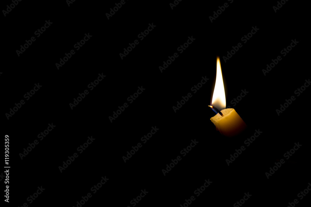 burning candle on dark background burning candle on dark background