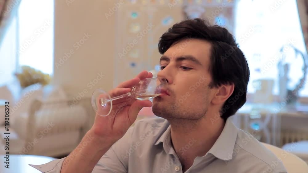 Man drinking champagne and talking in a restaurant Man drinking champagne and talking in a restaurant