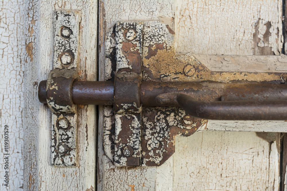 Old dilapidated gate latch bolt in locked position Old dilapidated gate latch bolt in locked position