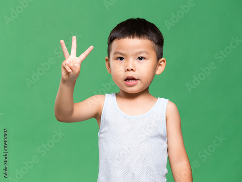 Little boy showing three finger