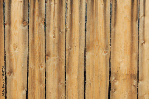 Texture wooden fence of planed boards yellow