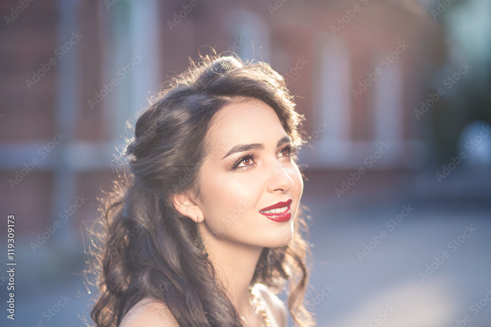 Portrait of young beautiful woman twenty five years old with dark brown or black hair outdoors on sunset. Lifestyle concept Portrait of young beautiful woman twenty five years old with dark brown or black hair outdoors on sunset. Lifestyle concept