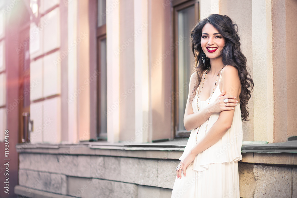 Beautiful girl walking on a warm sunny day in the city. Young brunette beautiful woman, lifestyle concept