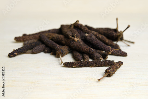 Long pepper or Pipli or Dipli (Piper longum) isolated on wood ba photo
