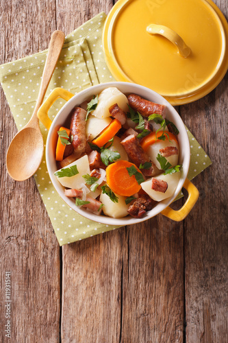 Traditional Irish dish is coddle with sausages, bacon and vegetables. Vertical top view
