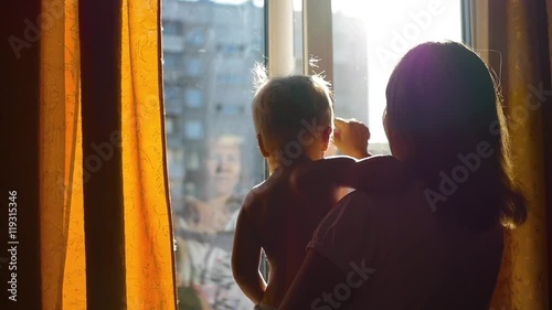 the girl opened the window on a Sunny day