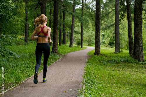 Young slim woman jogging in a park