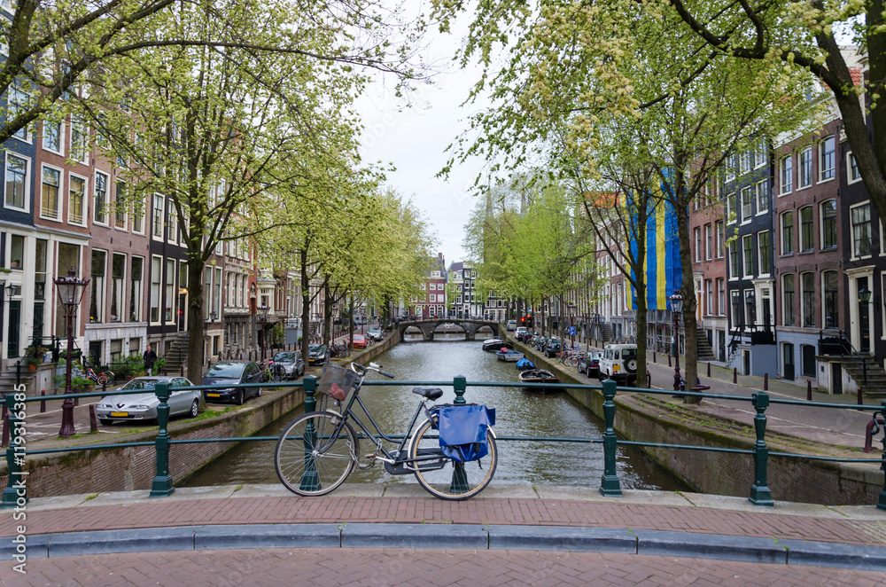 Fototapeta premium Bicycle lining a bridge over the canals of Amsterdam