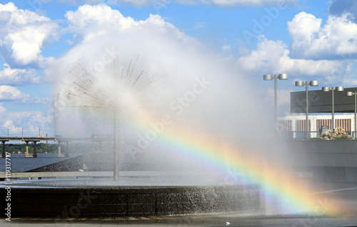 Fountain with rainbow near the river Dnieper against the backdrop of beautiful clouds, Dnepropetrovsk, Ukraine.